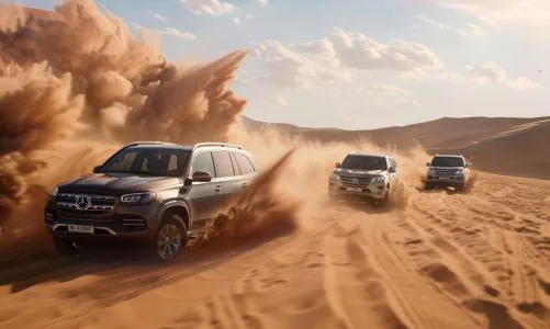Mercedes-Benz and Toyota SUVs racing across sand dunes in the UAE desert.